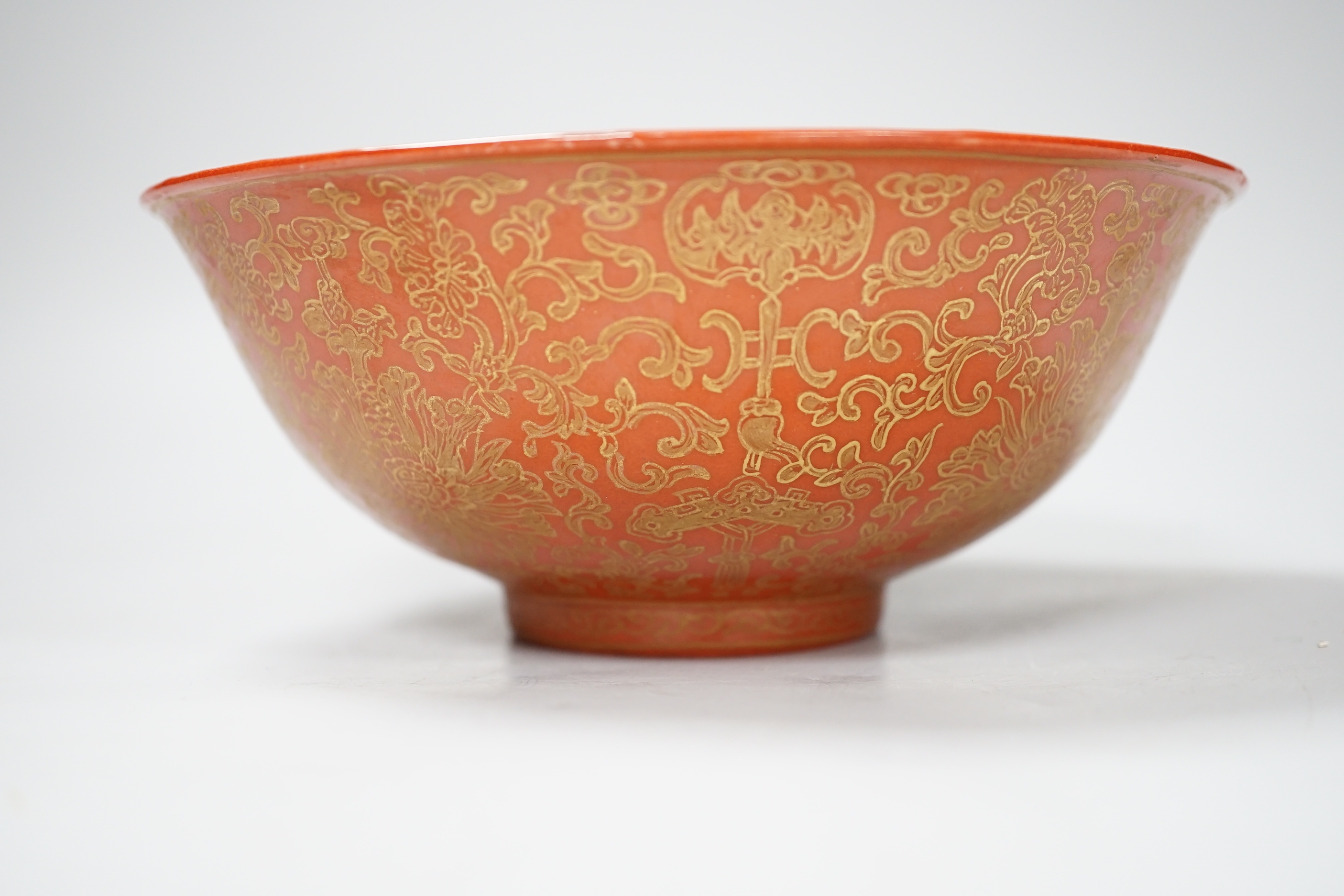 A Chinese gilded coral-ground bowl, 17cm diameter